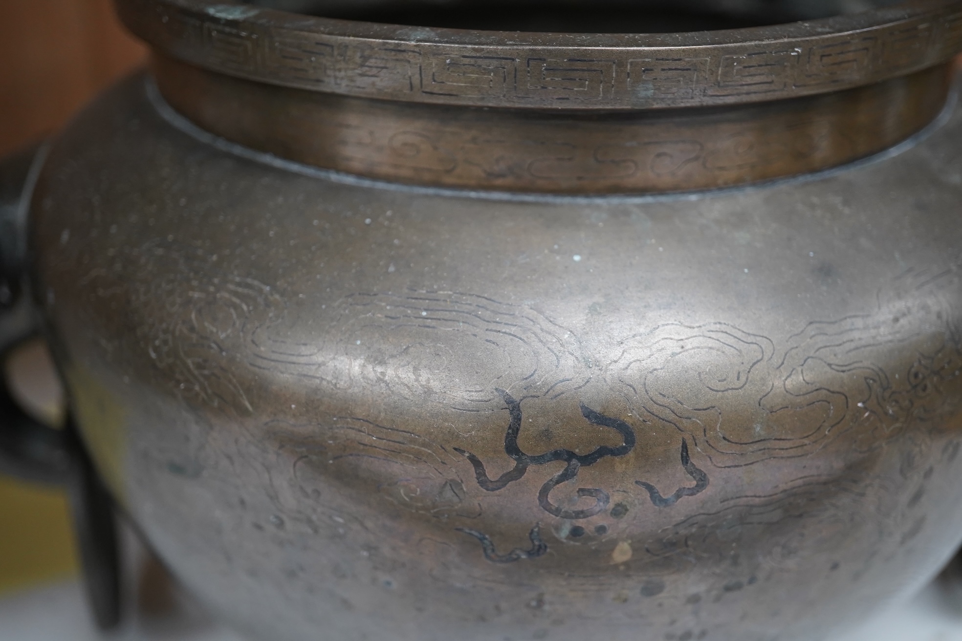 A large Chinese silver inlaid bronze elephant handled censer, signed Sishou, 19th century, 16cms high, 29cm wide. Condition - fair